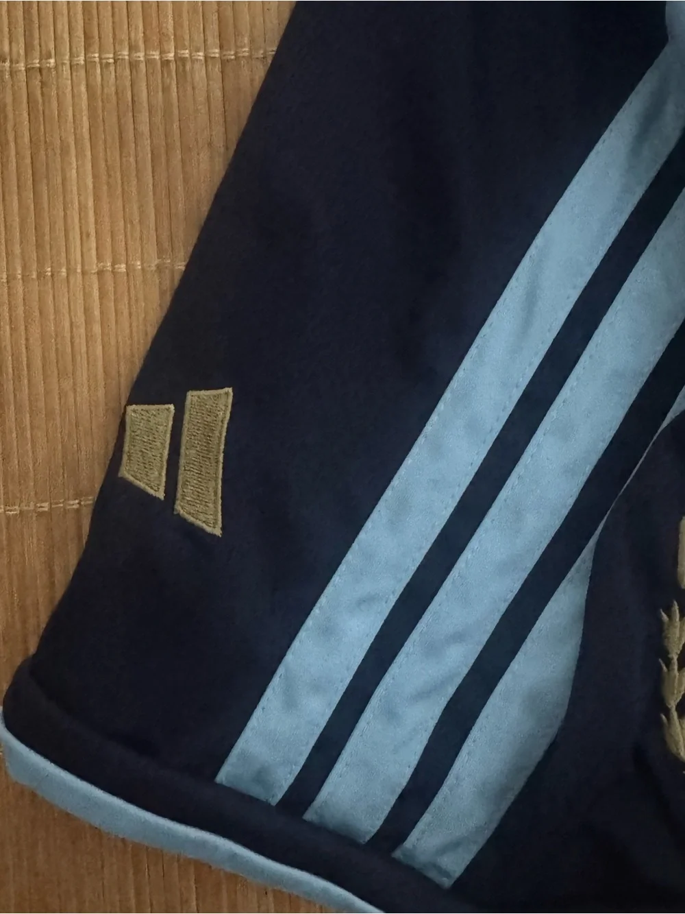 adidas Men's Black Athletic Shorts with Light Blue Stripes and Crest